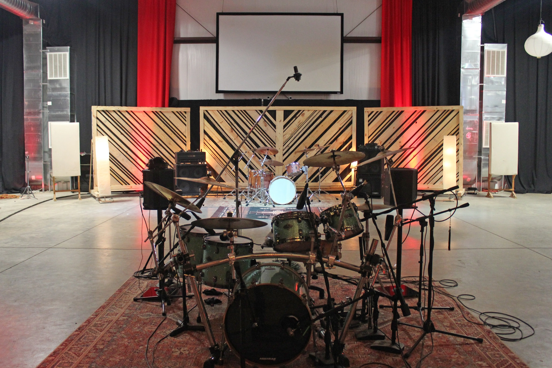 Drums set up at either end of studio floor